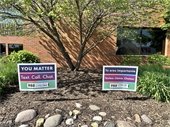 988 yard sign photos in front of village hall