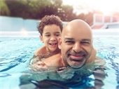 father and son in pool